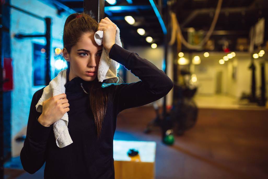 Tired woman in the gym