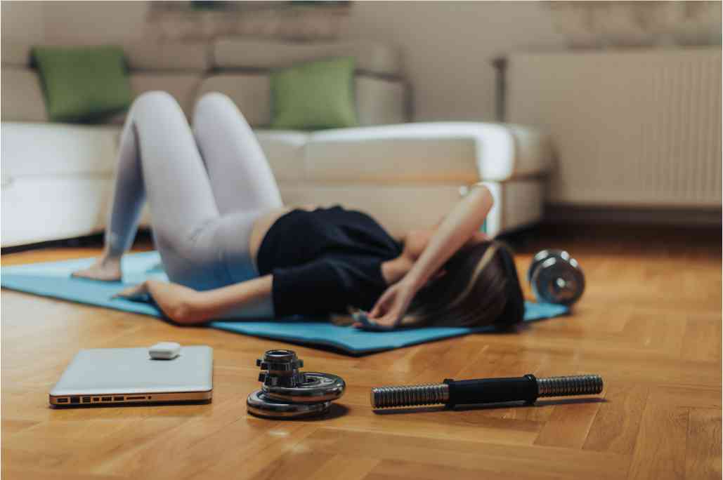 Woman lying on exercise mat