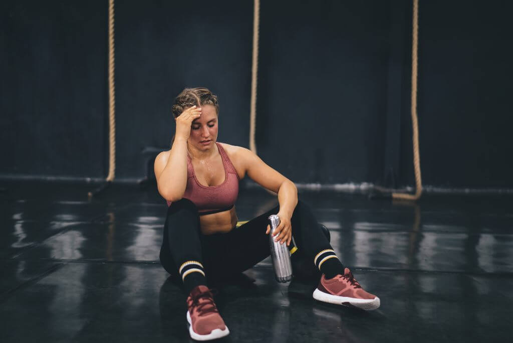 Woman sitting on the gym floor