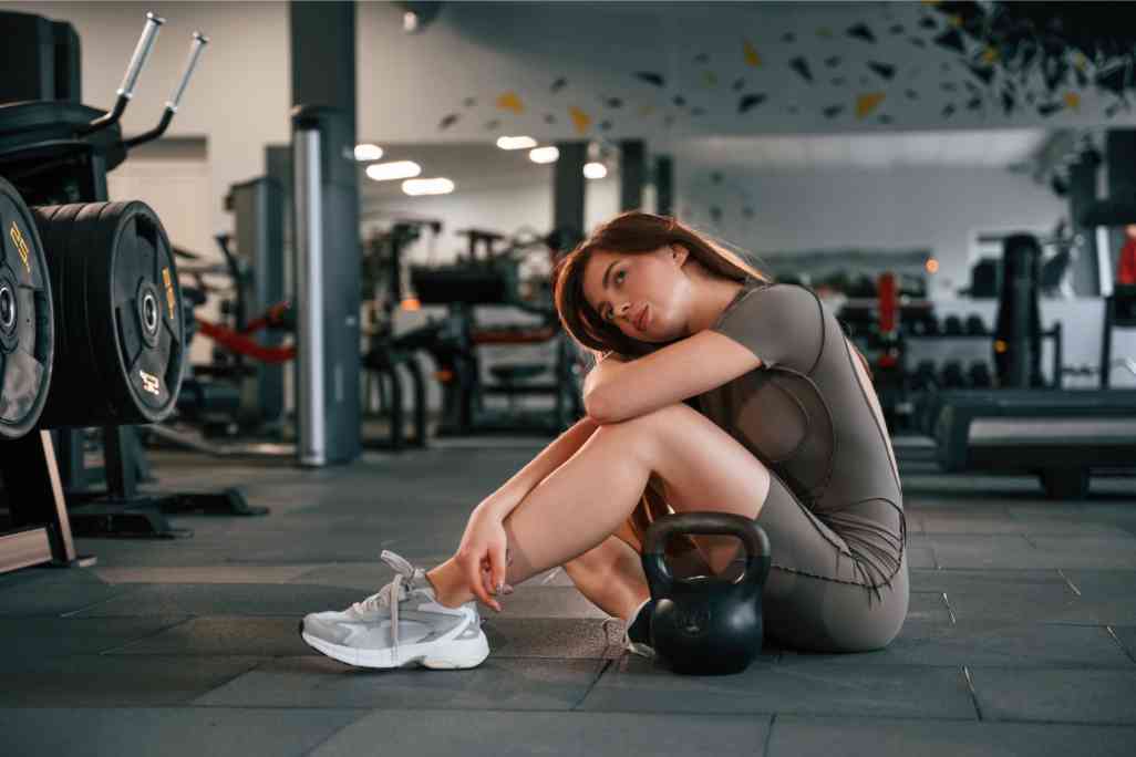 Woman sitting on the gym floor