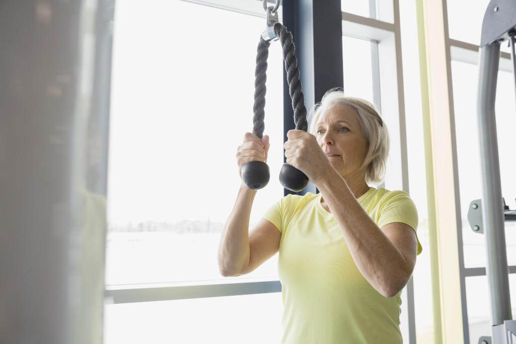 Woman using cable machine