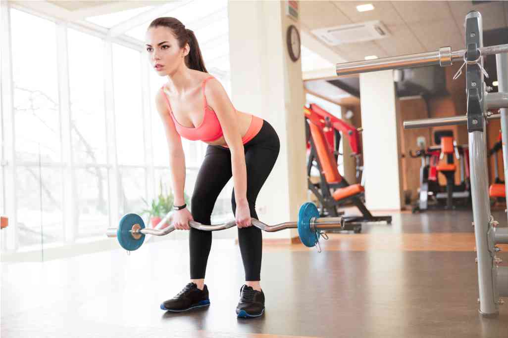 Young woman lifting weights